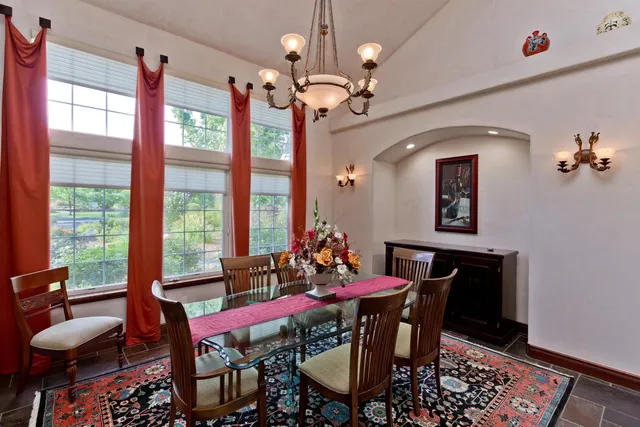 a view of a dining room with furniture and a chandelier