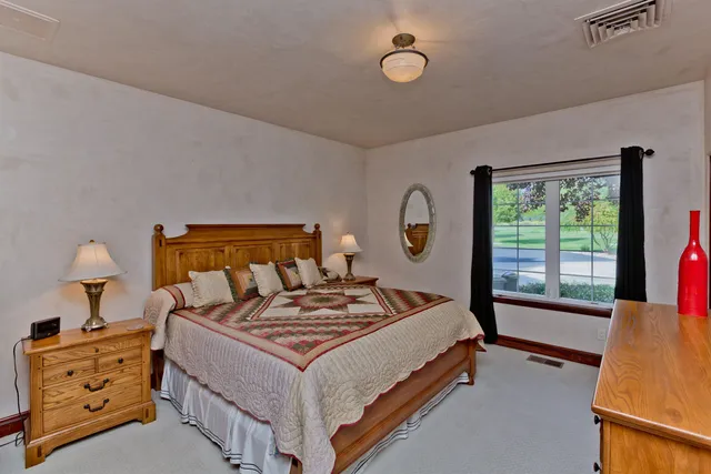 a bedroom with a bed and a window