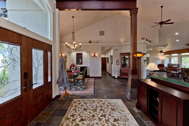a kitchen area with stainless steel appliances granite countertop a refrigerator and a sink