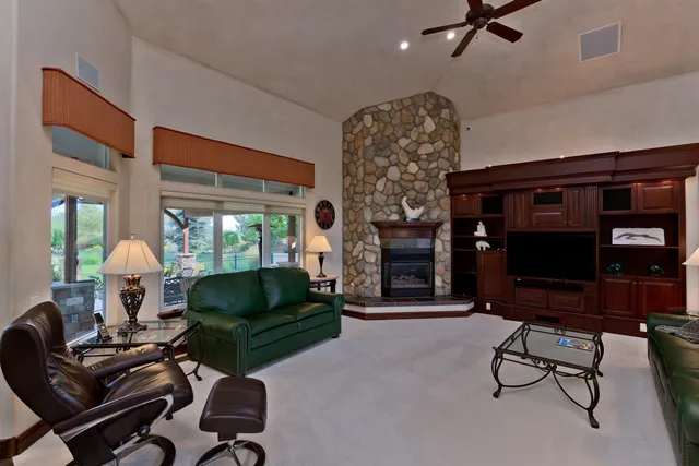 a living room with furniture a rug and a fireplace