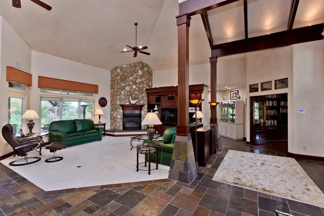 a living room with furniture a rug and white walls