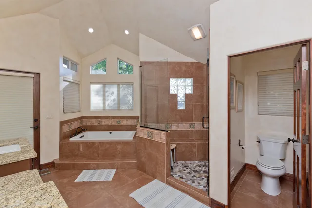 a spacious bathroom with a shower a toilet and a sink