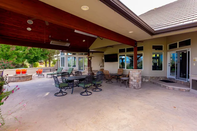 a view of a patio with table and chairs and potted plants