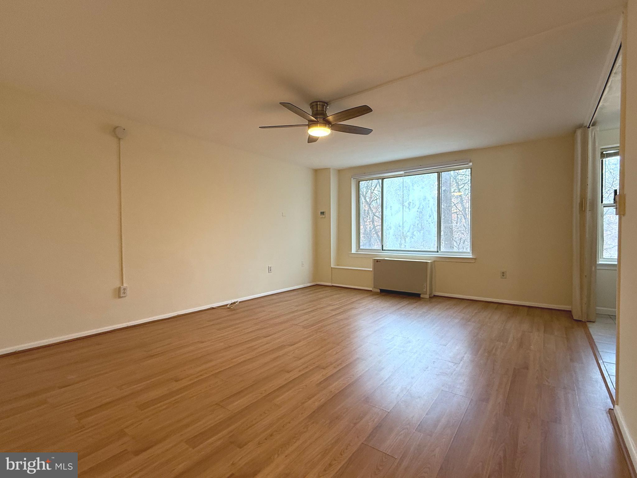4100 W Street Northwest, Unit 303 Washington, DC 20007 - Photo 2 of 15 wooden floor in an empty room with a window