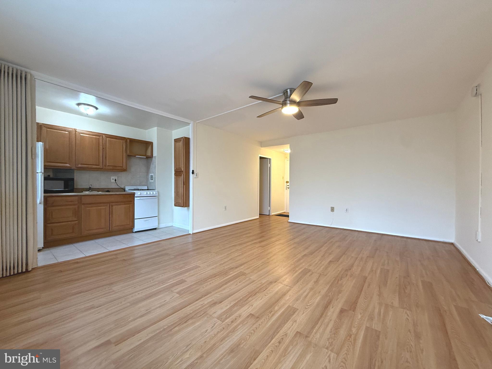 4100 W Street Northwest, Unit 303 Washington, DC 20007 - Photo 4 of 15 a view of a kitchen with a sink and a refrigerator