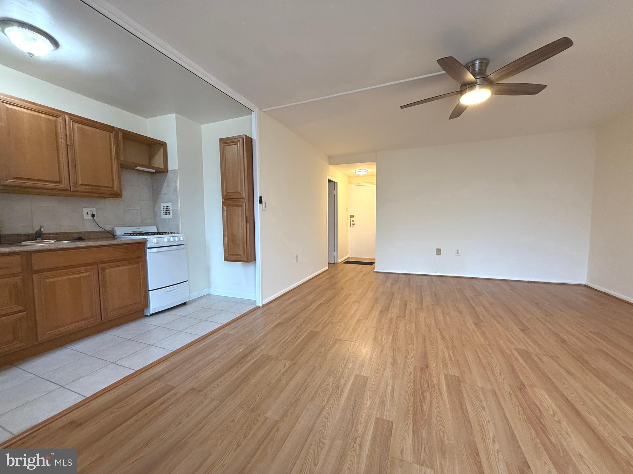 4100 W Street Northwest, Unit 303 Washington, DC 20007 - Photo 5 of 15 a view of a kitchen with a sink cabinets and wooden floor