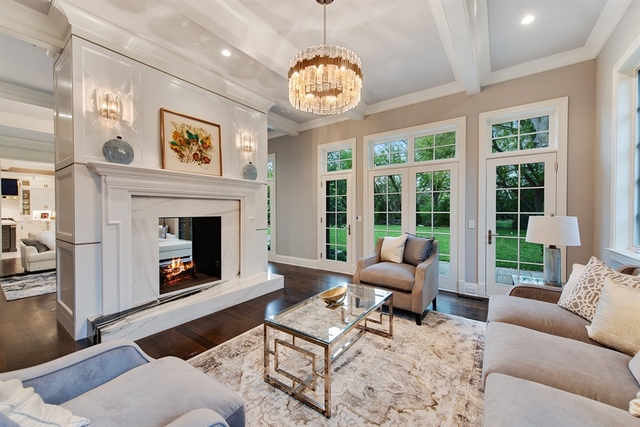 Undisclosed Address Glencoe, IL 60022 - Photo 13 of 30 a living room with furniture a chandelier and a fireplace