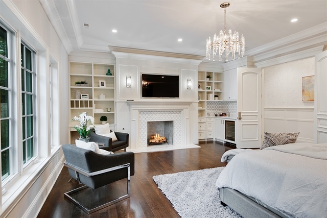 Undisclosed Address Glencoe, IL 60022 - Photo 16 of 30 a living room with furniture a flat screen tv and a fireplace