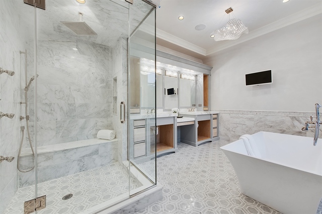 Undisclosed Address Glencoe, IL 60022 - Photo 17 of 30 a bathroom with a tub sink shower and mirror