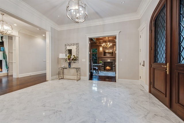 Undisclosed Address Glencoe, IL 60022 - Photo 6 of 30 an empty room with wooden floor and way to kitchen