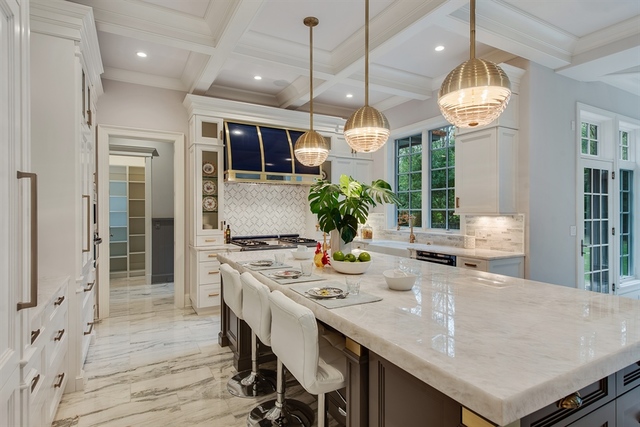 Undisclosed Address Glencoe, IL 60022 - Photo 8 of 30 a kitchen with stainless steel appliances granite countertop a sink a stove and a dining table with wooden floor