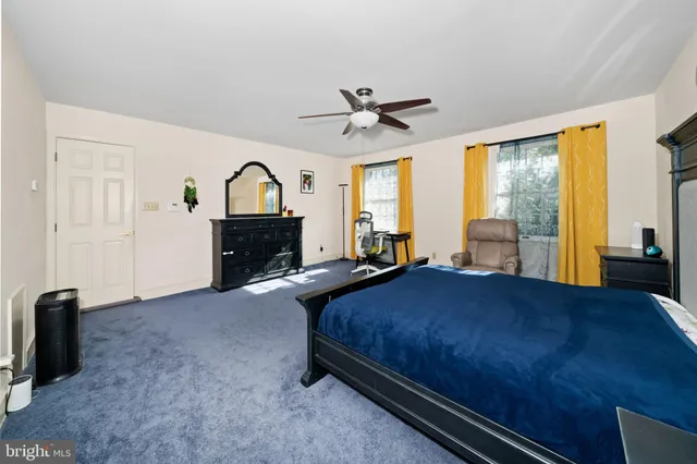 a bedroom with a bed and a night stand