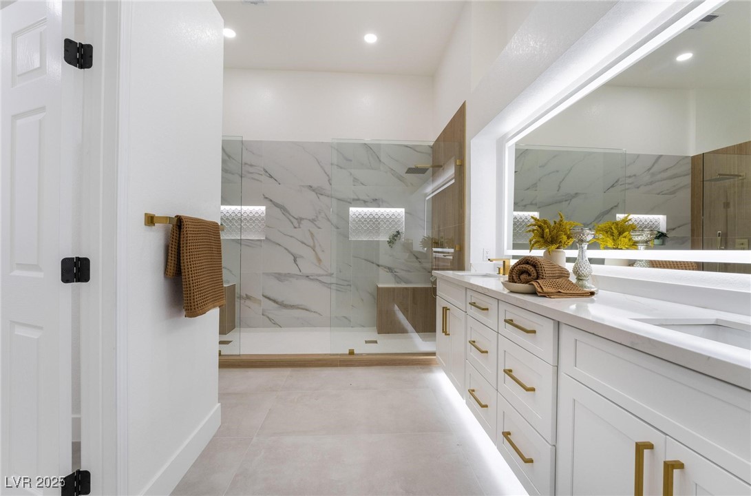 2528 Sunup Drive Las Vegas, NV 89134 - Photo 13 of 24 Bathroom featuring double vanity and a marble finish shower