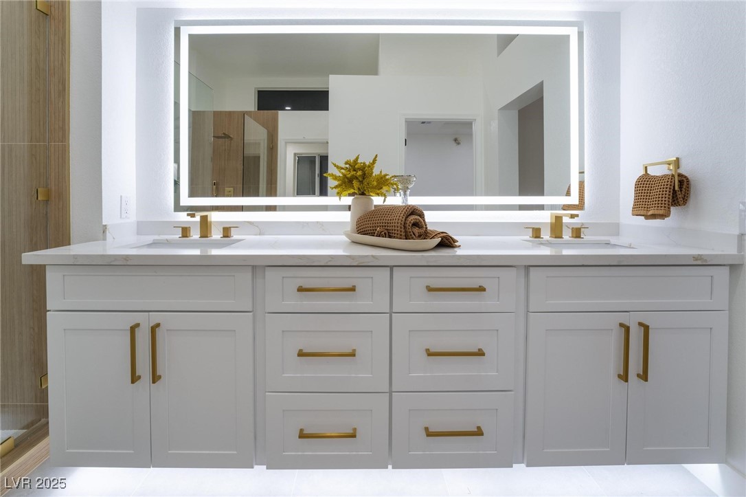 2528 Sunup Drive Las Vegas, NV 89134 - Photo 14 of 24 Bathroom featuring a shower stall, double vanity, and light tile patterned floors