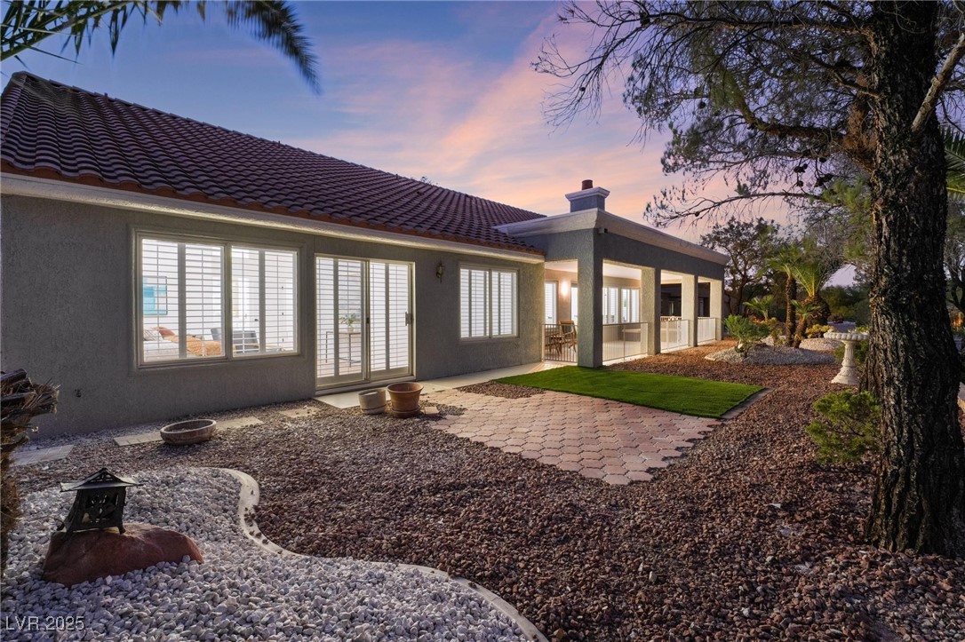 2528 Sunup Drive Las Vegas, NV 89134 - Photo 19 of 24 Rear view of property with a patio, a chimney, stucco siding, and a tile roof