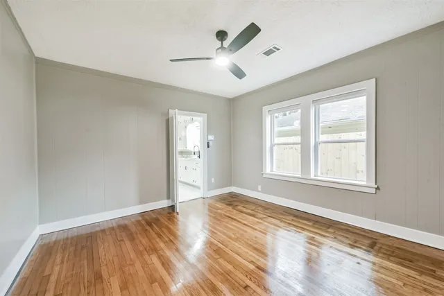 a kitchen with sink a refrigerator and white cabinets