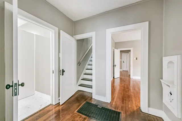 a view of a room with wooden floor
