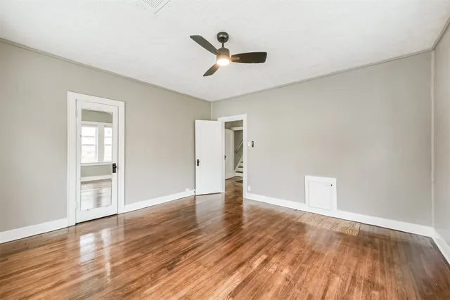 a bedroom with furniture and wooden floor