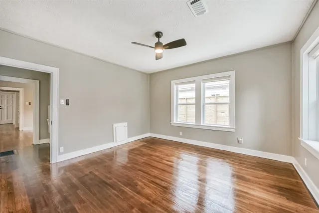 a view of a hallway with furniture and wooden floor