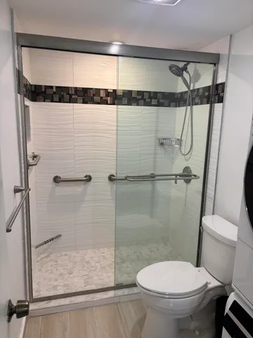 a view of swimming pool with outdoor seating and buildings in the background