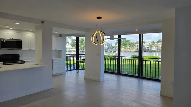 a bedroom with a bed and large windows