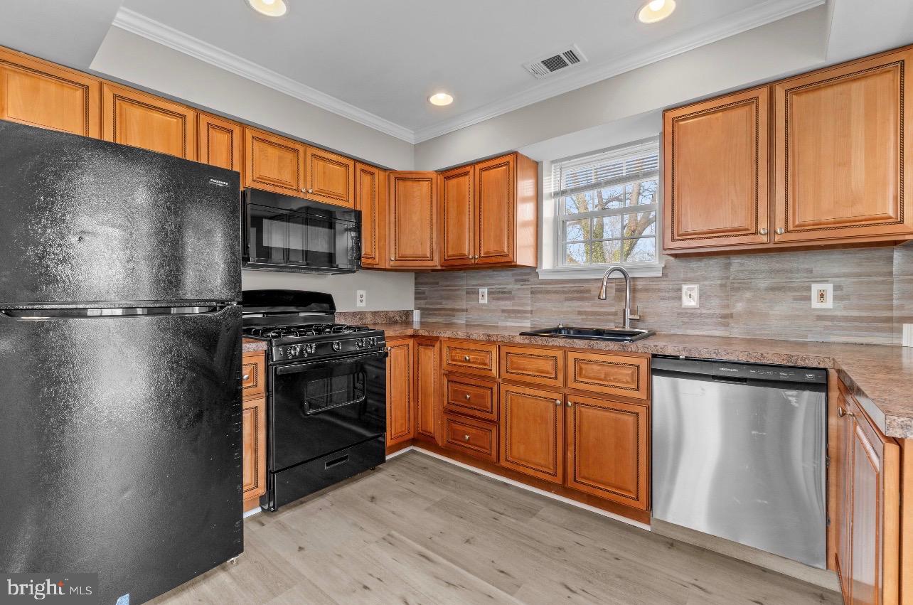 2528 Wendover Road, Unit A Baltimore, MD 21234 - Photo 9 of 18 Modern kitchen with rich wood cabinetry.