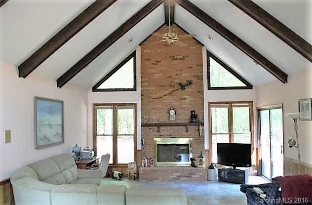 5214 Davis Road Waxhaw, NC 28173 - Photo 4 of 24 a living room with furniture a flat screen tv and a fireplace