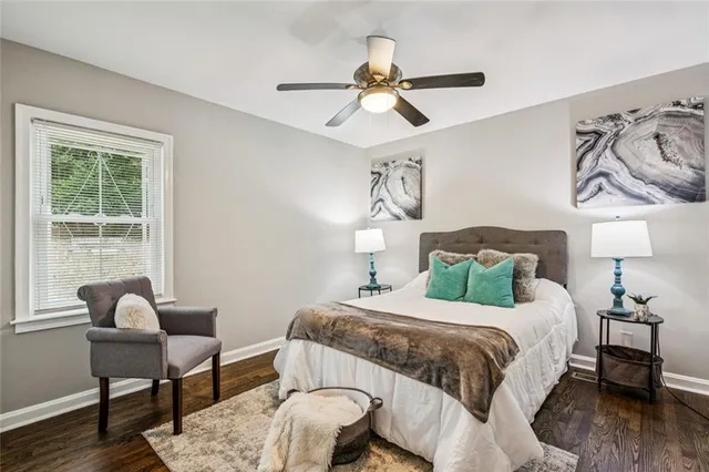 a bathroom with a sink a mirror and a potted plant