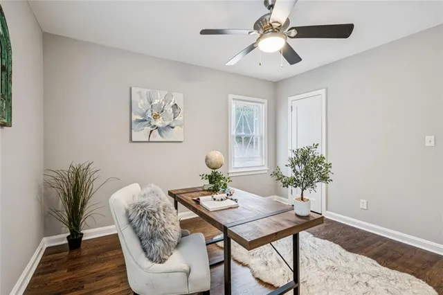 a workspace with wooden floor and a window