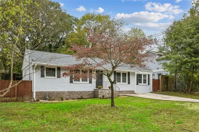a front view of a house with a garden