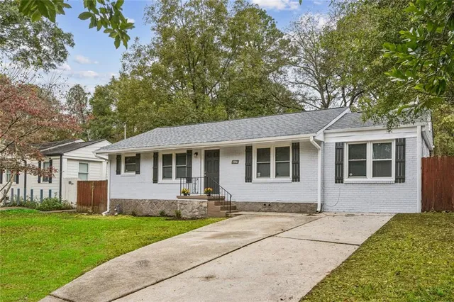 a front view of a house with a garden