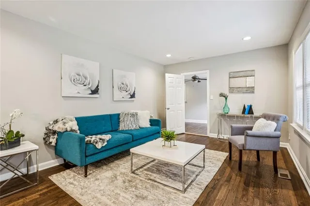 a living room with furniture and wooden floor