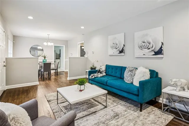 a living room with kitchen island furniture and a chandelier
