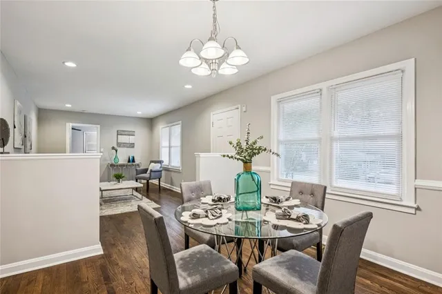 a view of a dining room with furniture a chandelier and wooden floor