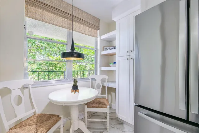 a dining room with furniture and window