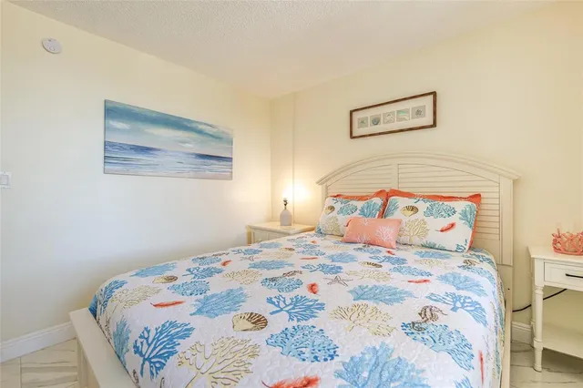 a bedroom with a bed and a painting on the wall