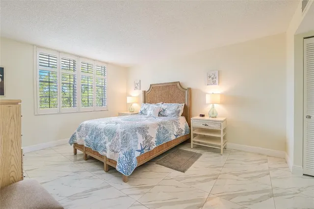 a bedroom with a bed and a table