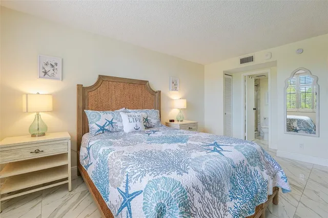 a bedroom with a bed and a lamp