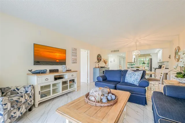 a living room with furniture a rug and a flat screen tv