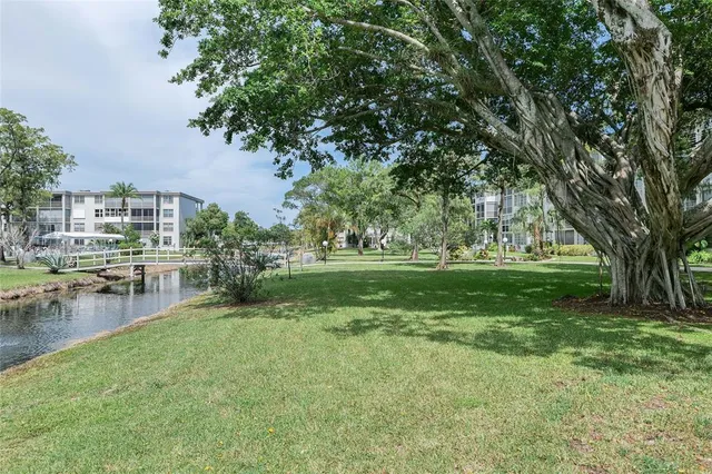 a front view of a building with a garden and plants