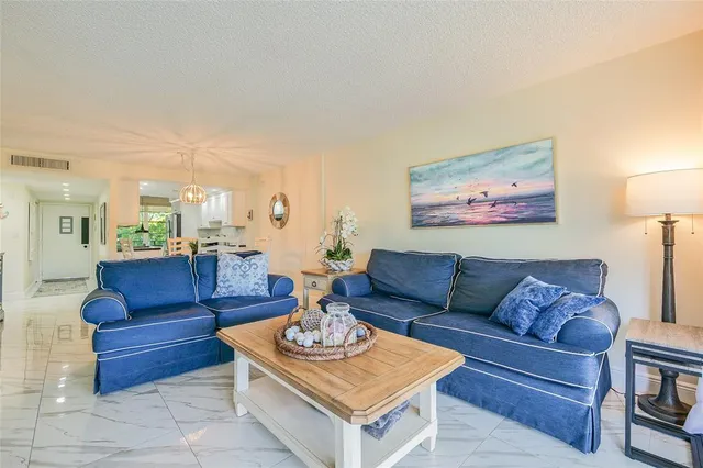 a living room with furniture a rug and a painting on the wall