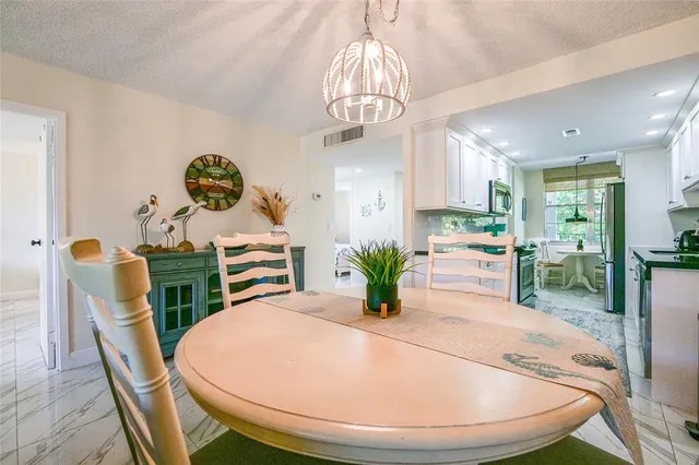 a view of a dining room with furniture wooden floor and chandelier