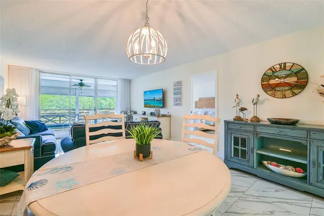 a dining room with furniture a fireplace and large windows