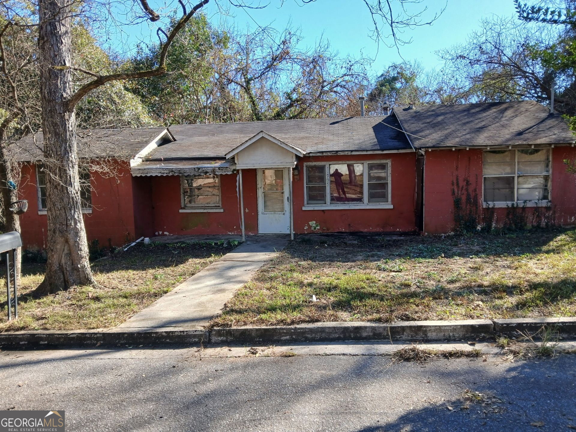 a house that has a tree in front of it
