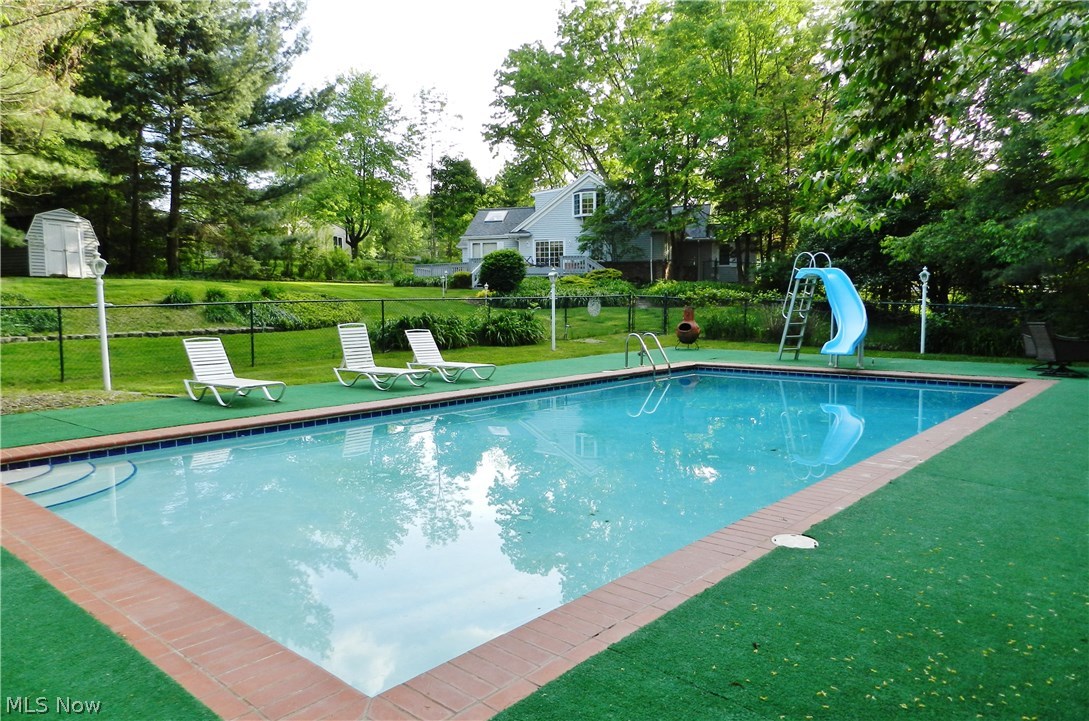 30065 Bolingbrook Road Pepper Pike, OH 44124 - Photo 24 of 33 Imagine enjoying the heated pool all summer long. The yard is fenced -- then the pool is fenced as well, a safety feature that lets kids and dogs enjoy the spacious yard. The shed at left is for storing pool and lawn equipment. View is toward the house and back deck.