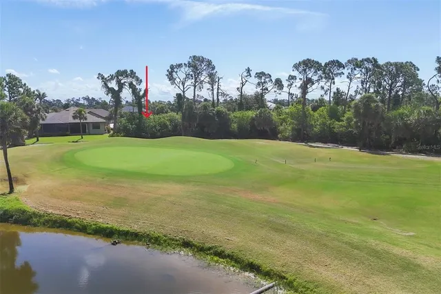 a view of a lake with a house in the background