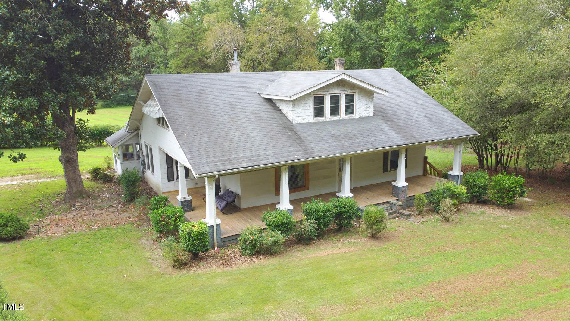 a aerial view of a house with a yard and plants