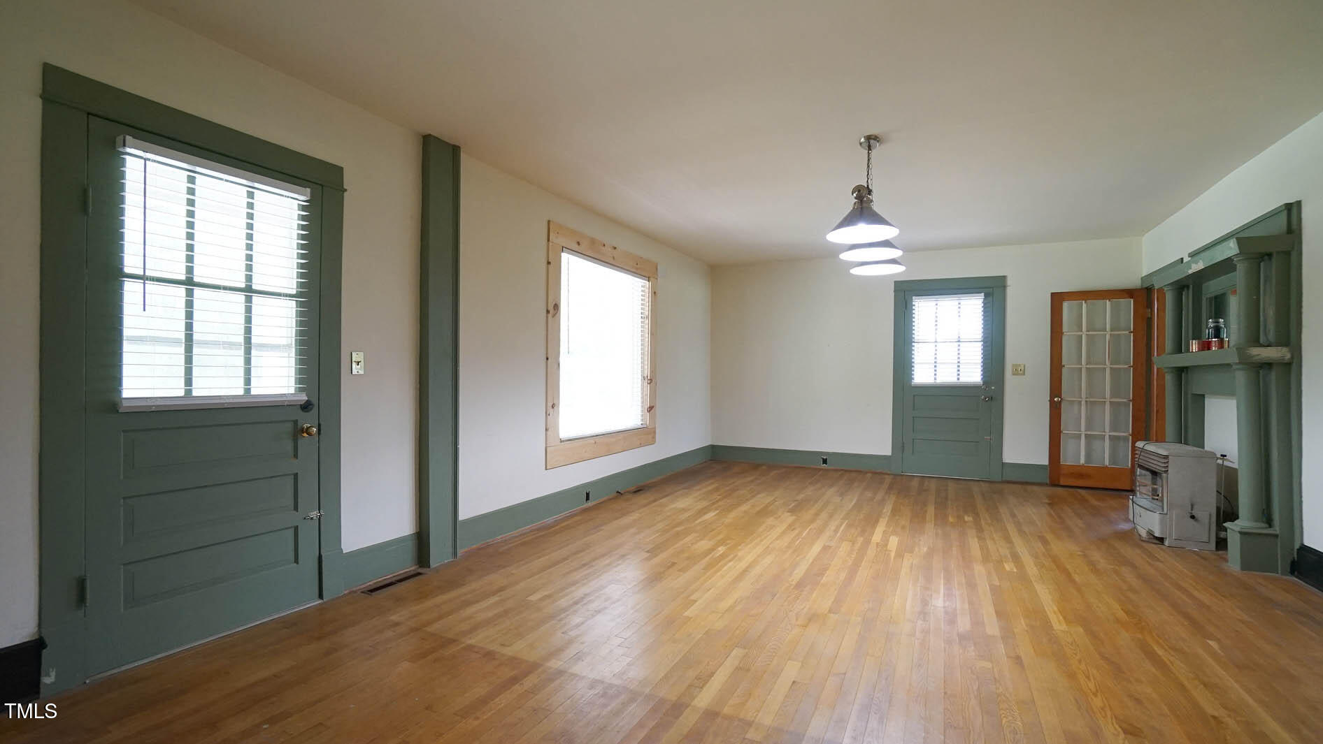 131 King Road Warrenton, NC 27589 - Photo 13 of 67 an empty room with wooden floor and windows