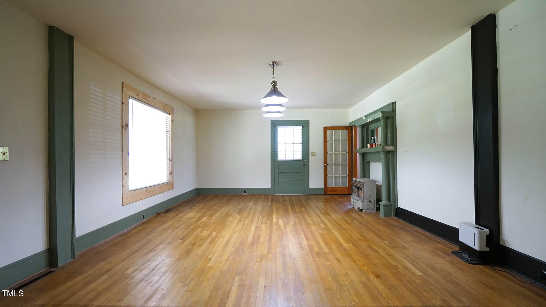 131 King Road Warrenton, NC 27589 - Photo 14 of 67 an empty room with wooden floor and windows