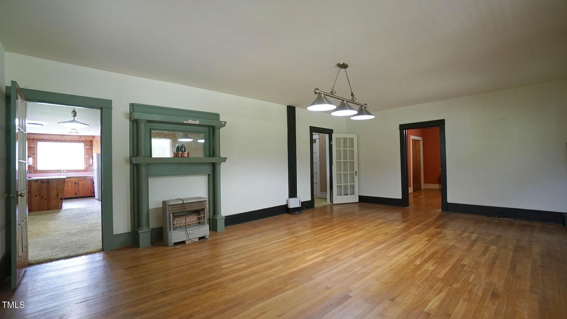 131 King Road Warrenton, NC 27589 - Photo 16 of 67 an empty room with wooden floor mirror and windows